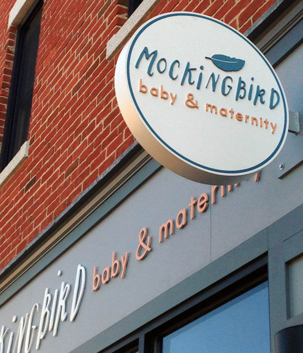 Mockingbird brand identity extended to store signage: indoor, outdoor, and window