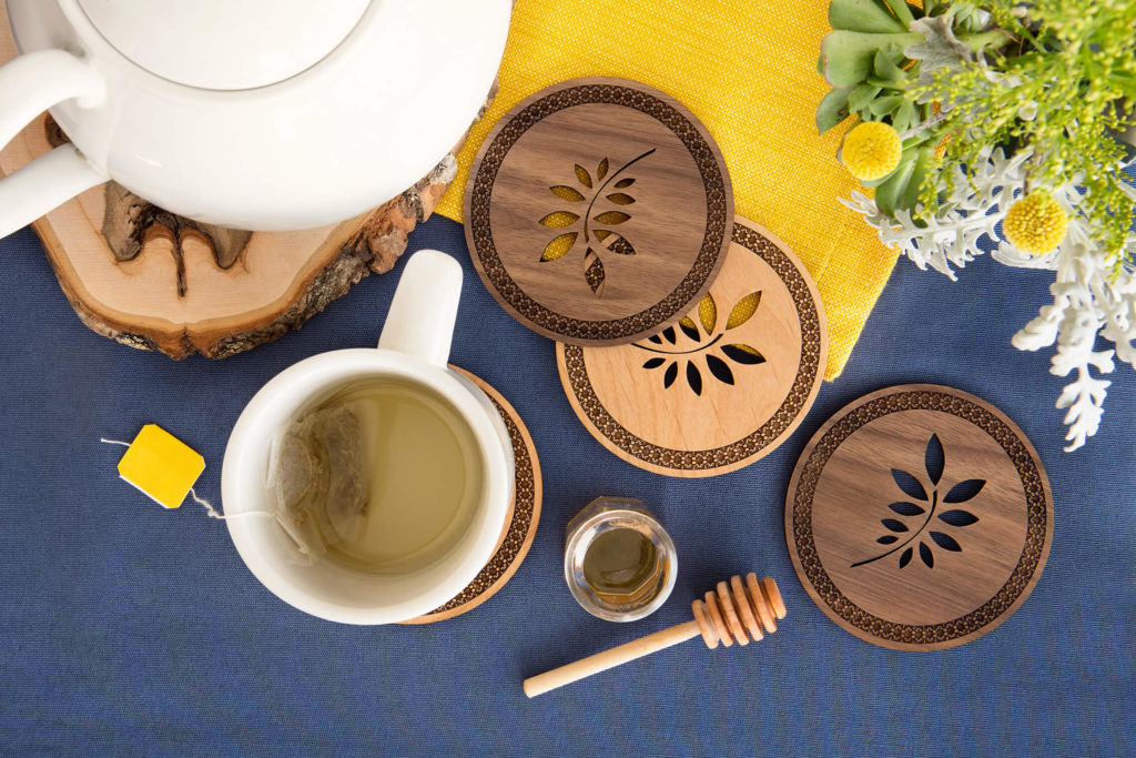 Photo of wooden coasters and a table set for tea.