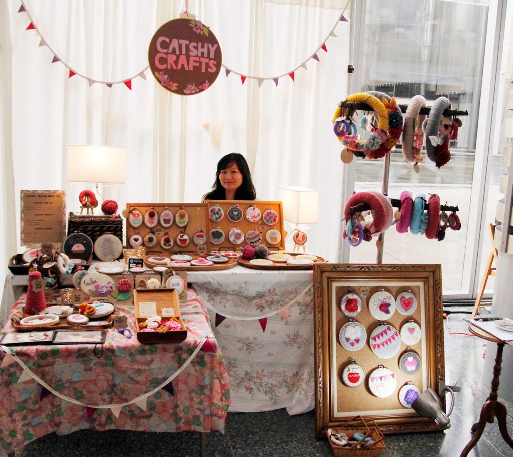 A successful trade show seller at her craft booth