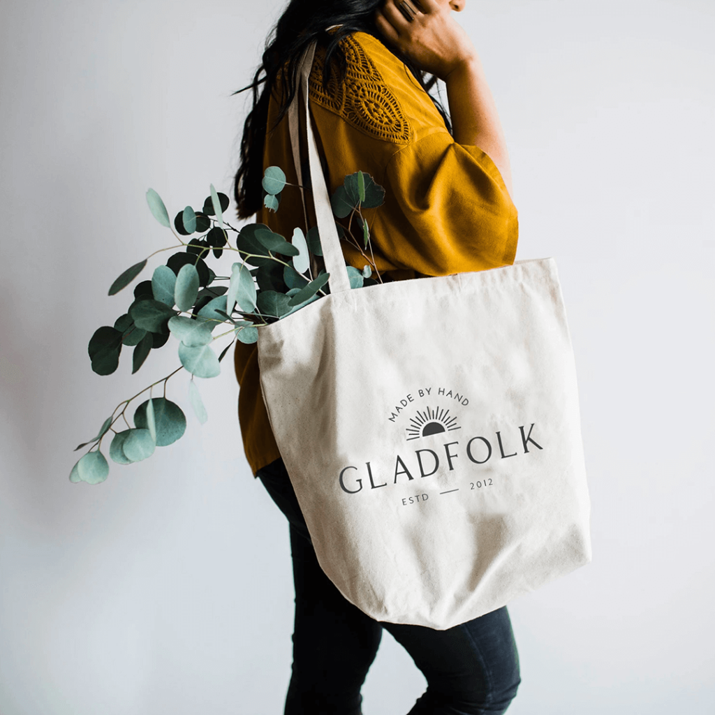 Gladfolk tote bag design with black lettering on natural canvas.