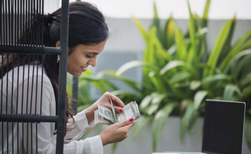 An entrepreneur counting money to illustrate our financing guide