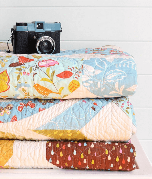 Styled photos like this stack of quilts can help drive traffic from instagram to your online store.