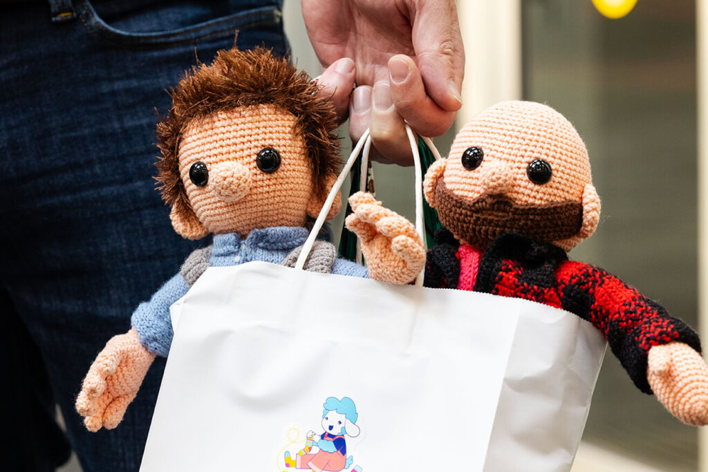 two crochet dudes in a shopping bag