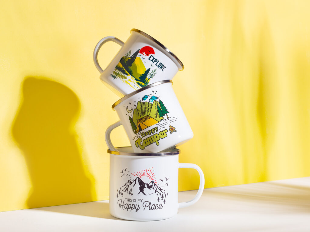 a stack of camping mugs with a yellow background